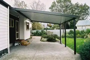 A carport with a metal roof attached to a house.
