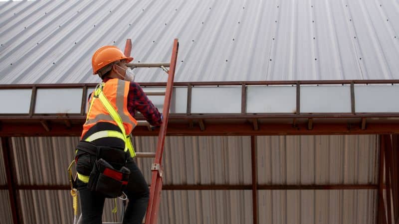 Expert checking roof to avoid common roof design mistakes